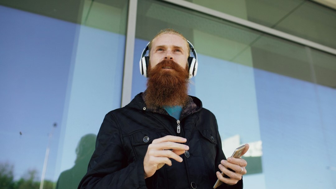 Male video training instructor with a beard and headphones